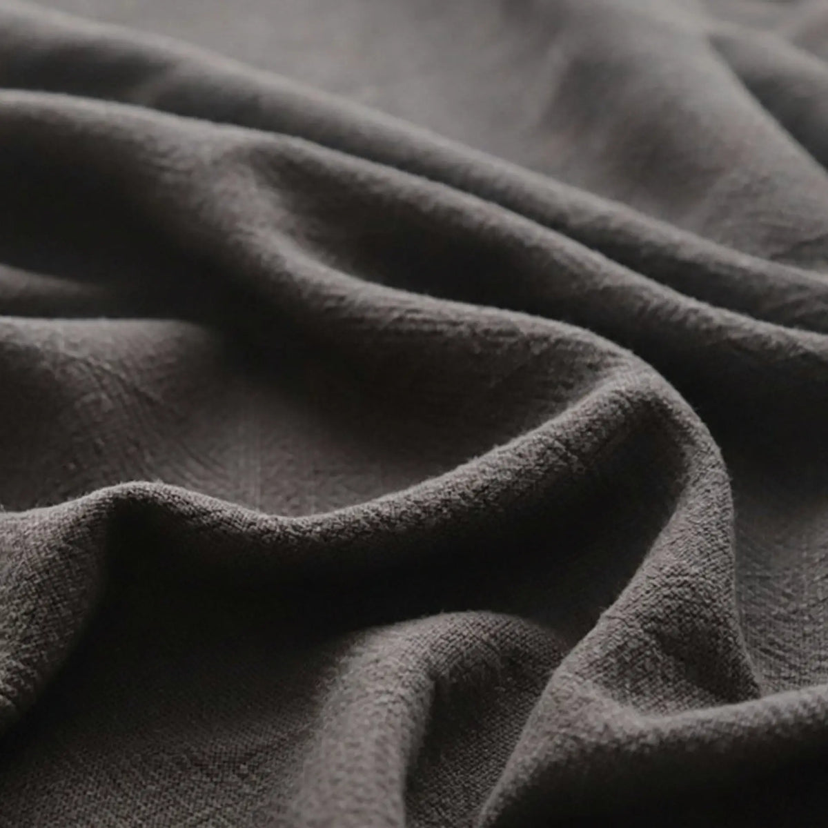 Close-up of Longan Craft's Solid Color Rayon Linen Fabric By The Yard, a thick, washed slub viscose material with a soft, textured woven surface and gentle folds, perfect for dresses and clothing projects.