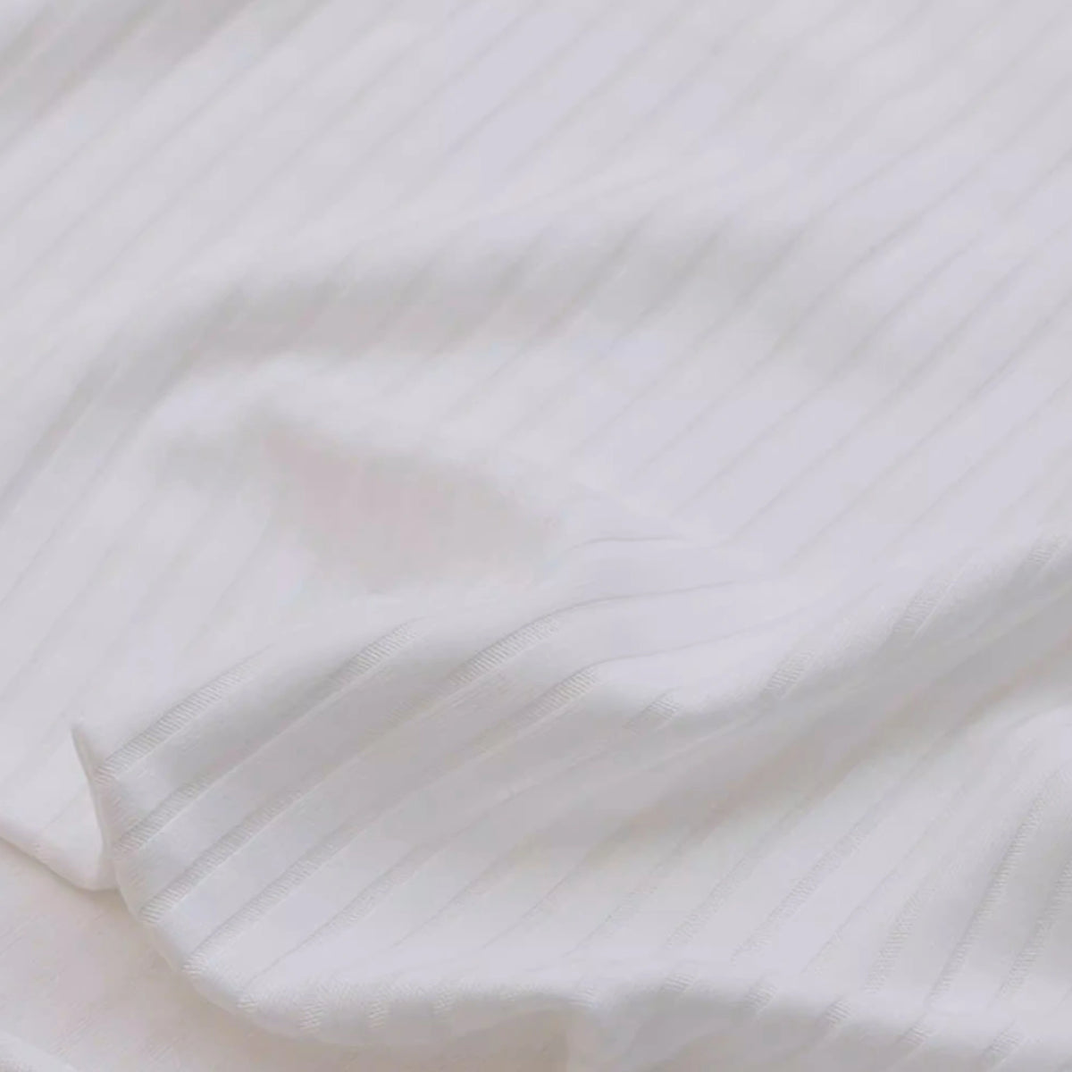 Close-up of Longan Craft’s Solid Color Ribbed Viscose Fabric by the Yard, featuring soft textured stretch elastane material with subtle pinstripes—ideal comfy textile for DIY t-shirts.