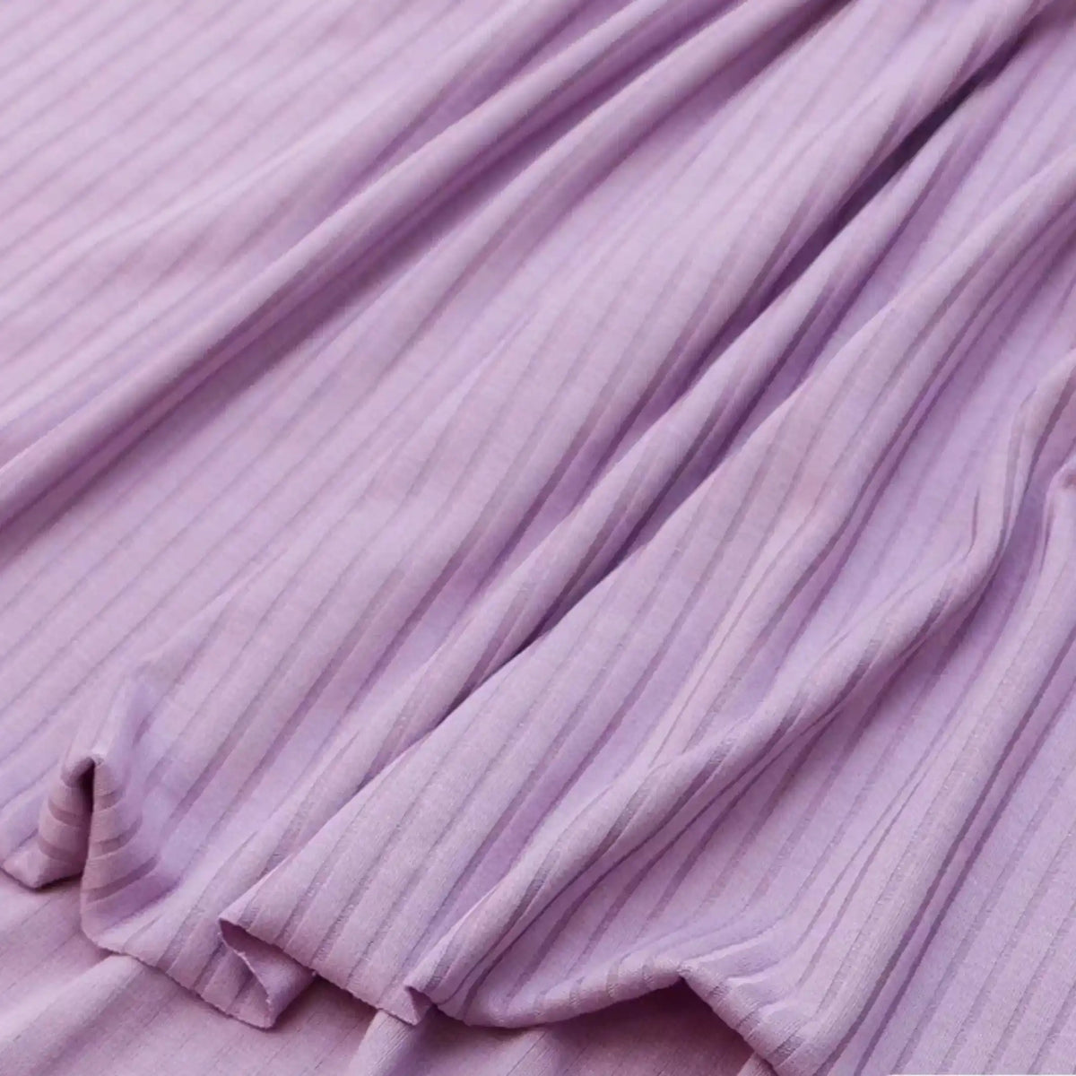 Close-up of Solid Color Ribbed Viscose Fabric by the yard from Longan Craft, featuring light purple stretch elastane material with vertical ribbed texture, ideal for comfy DIY T-shirts and garments.