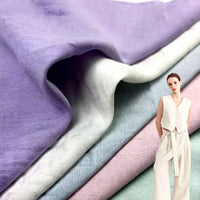 Close-up of Longan Craft's Solid Color Viscose Lyocell Fabric By The Yard in lavender, white, blue, and pink—a smooth, breathable Rayon and Linen Blend textile—shown with a woman wearing a light sleeveless lyocell top and wide-leg pants.