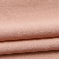 Close-up of Longan Craft’s Solid Color Washed Crepe Fabric By The Yard, a soft, light pink 100% cotton material featuring a slightly textured crepe surface and neatly folded in horizontal layers—ideal for pants and clothing projects.