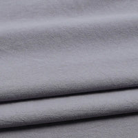 Close-up of Longan Craft Solid Color Washed Crepe Fabric By The Yard, featuring 100% cotton crepe material in light gray with a soft, textured surface, shown gently draping and folding—ideal for pants and clothing projects.