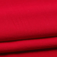 Here’s a rewritten sentence using your provided product data: Close-up of Longan Craft’s Solid Color Washed Crepe Fabric By The Yard, made from 100% cotton. The bright red crepe material is neatly folded in layers, showcasing its smooth, slightly matte finish and soft textured surface—perfect for pants and other clothing projects.