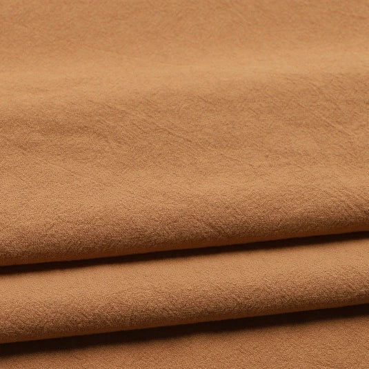 Three layers of Longan Craft’s Solid Color Washed Crepe Fabric By The Yard, made from 100% cotton, are stacked to highlight their soft, textured surface and subtle creases—making this crepe clothing material ideal for pants or other apparel projects.