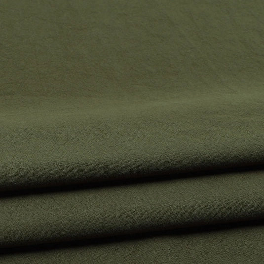 Close-up of folded olive green Solid Color Washed Crepe Fabric by the yard from Longan Craft, made of 100% cotton with a soft, textured crepe surface, gentle creases, and a matte finish—ideal for pants and clothing projects.