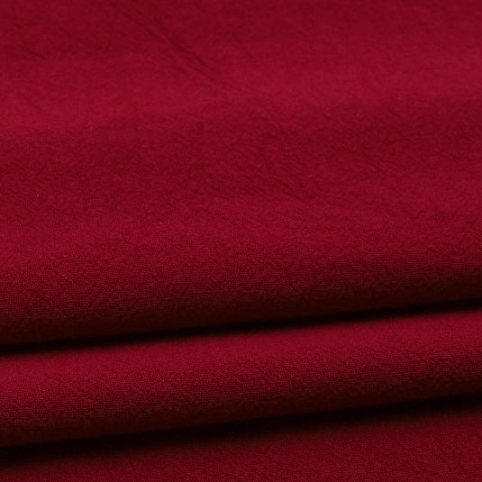 Close-up of folded Longan Craft Solid Color Washed Crepe Fabric by the yard, made from 100% cotton with a soft, smooth texture and gentle creasing—ideal for pants and clothing projects.