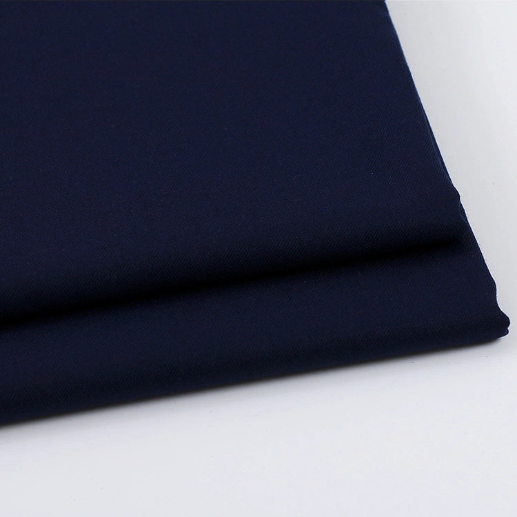 A close-up of neatly folded Solid Color Wool Gabardine Fabric By The Yard from Longan Craft, a rayon polyester blended twill gabardine textile, on a white surface, highlighting its smooth texture and clean edges—ideal for casual wear.