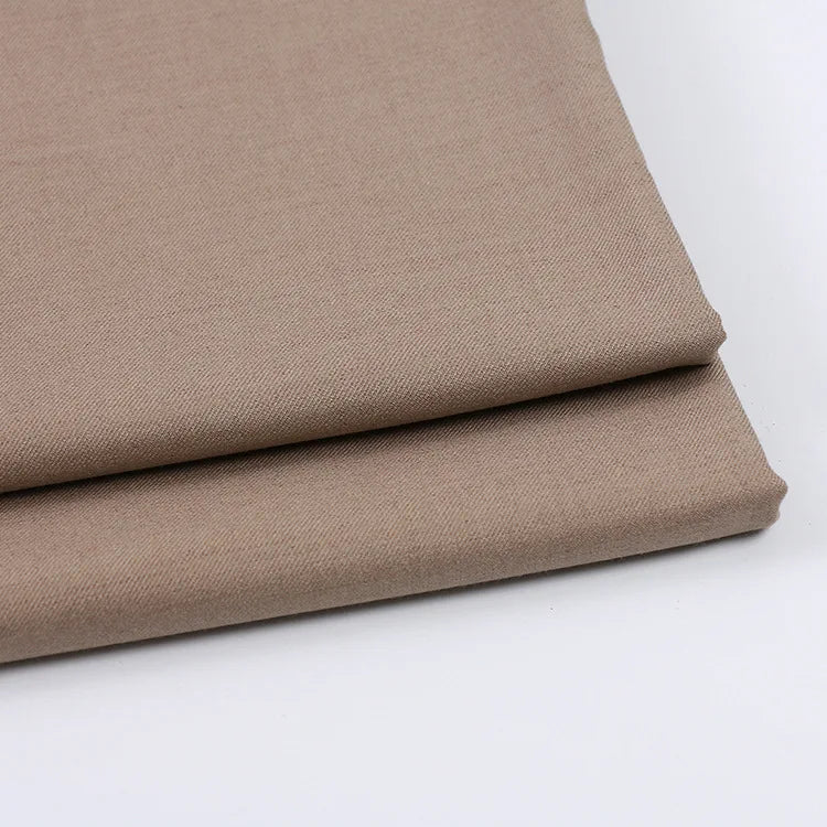 Two neatly folded pieces of Longan Craft Solid Color Wool Gabardine Fabric (Rayon Polyester Blended Twill), perfect for casual wear, are shown on a white background.