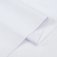 A close-up of Longan Craft's Solid Cotton Lawn Fabric by the yard shows its smooth, soft, and lightweight polyester lawn cloth material, neatly folded at the corner on a flat surface—ideal cozy dress fabric.