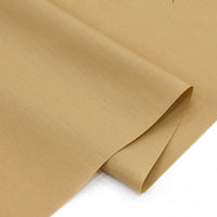 A close-up of Longan Craft Solid Cotton Lawn Fabric by the yard, a cozy cotton-polyester lawn cloth with a smooth texture, slight sheen, and fine weave details, neatly folded and light brown or beige in color.