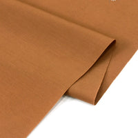 A close-up of Longan Craft's Solid Cotton Lawn Fabric by the yard, a smooth, lightweight, and cozy polyester lawn cloth perfect for breathable dress projects, shown neatly folded on a white surface.