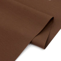 A close-up of smooth, brown Solid Cotton Lawn Fabric By The Yard from Longan Craft, neatly folded on a white surface—premium polyester lawn cloth material ideal for cozy dressmaking.