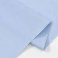 A close-up of Longan Craft’s Solid Cotton Lawn Fabric By The Yard, a light blue cotton-polyester lawn cloth with a smooth texture and clean edges, shown neatly folded against a white background.