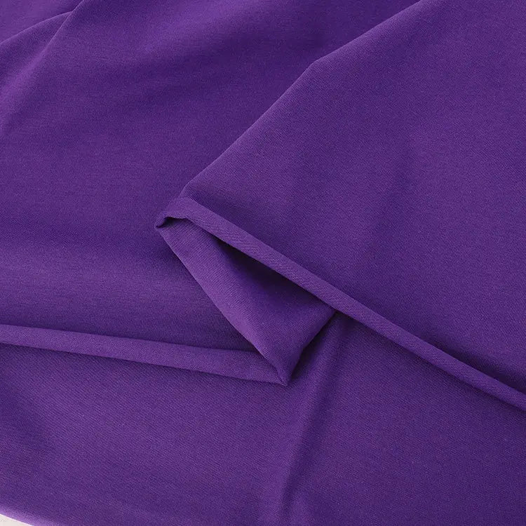 A close-up of Longan Craft’s Spandex Jersey Fabric By The Yard shows its smooth, folded solid color cotton jersey with a soft texture and four-way stretch—ideal as stretch jersey dress fabric.