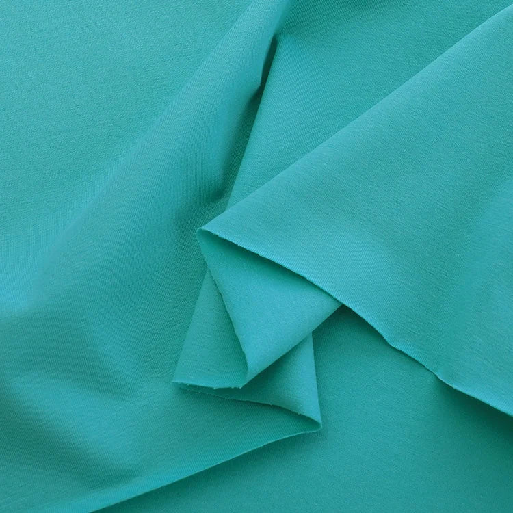 Close-up of Longan Craft's Spandex Jersey Fabric By The Yard in teal, featuring smooth, soft cotton jersey with four-way stretch, ideal for dressmaking and crafts.