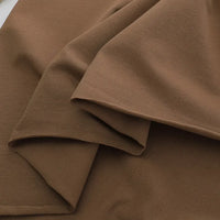A close-up of Longan Craft’s Spandex Jersey Fabric By The Yard in light brown, neatly folded to highlight its smooth texture, soft feel, and four-way stretch—ideal as a solid color cotton jersey dress fabric.