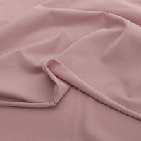 A close-up of Longan Craft’s Solid Color Cotton Spandex Jersey Fabric By The Yard, draped in gentle folds to highlight its soft, matte texture and subtle four-way stretch—ideal as a stretch jersey dress fabric.