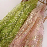 Two pieces of Sparkle Glitter Tulle Fabric by Longan Craft—one green, one light pink—have a sheer texture with gold glittery patterns, perfect for evening gowns or bridal veils. This delicate multicolor shiny tulle is sold by the yard.