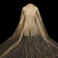 A mannequin displays Longan Craft's Sparkle Glitter Tulle Fabric By The Yard, a multicolor, shimmering tulle perfect for evening gowns, draped elegantly to the floor against a black backdrop.