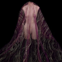 A mannequin displays Longan Craft’s Sparkle Glitter Tulle Fabric By The Yard—delicate multicolor shiny tulle for evening gowns—its purple and gold shimmer with wavy patterns standing out brilliantly against a black background.