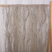 A panel of Sparkle Glitter Tulle Fabric By The Yard from Longan Craft hangs on a wooden rod, featuring multicolor shimmer and delicate patterns that add a touch of elegance perfect for evening gowns.