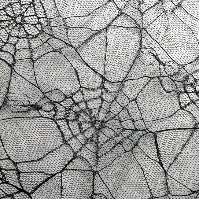 Close-up of a detailed spider web on fine mesh, similar to Longan Craft’s Spider Web Tulle Fabric By The Yard—a colorful Halloween tulle perfect for DIY party dresses and decorations.
