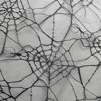 Close-up of a detailed spider web on fine mesh, similar to Longan Craft’s Spider Web Tulle Fabric By The Yard—a colorful Halloween tulle perfect for DIY party dresses and decorations.
