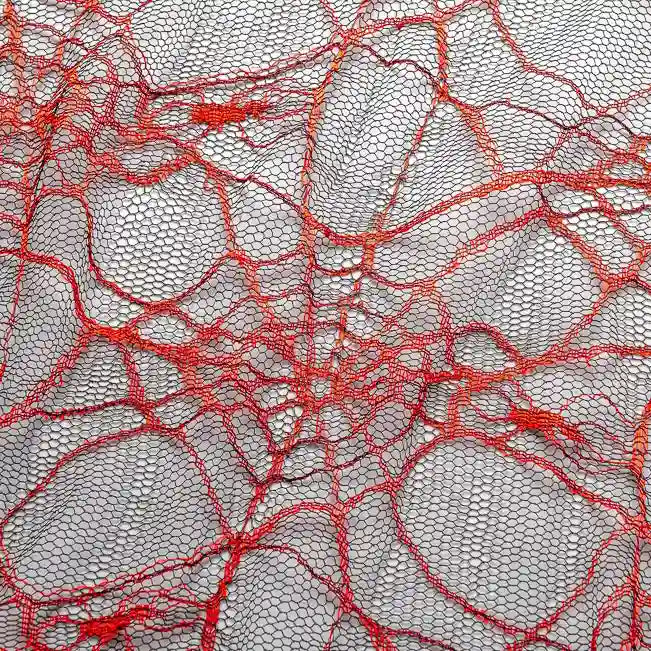 Close-up of Longan Craft's Spider Web Tulle Fabric By The Yard, a colorful Halloween tulle material with an irregular red web pattern on light mesh—ideal for spooky DIY party dresses and festive decorations.