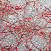 Close-up of Longan Craft's Spider Web Tulle Fabric By The Yard, a colorful Halloween tulle material with an irregular red web pattern on light mesh—ideal for spooky DIY party dresses and festive decorations.