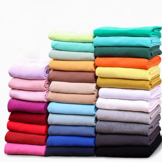 A selection of Longan Craft's Stretch Cotton French Terry Fabric by the yard in green, blue, yellow, orange, red, pink, brown, gray, and white—cozy multicolor knit material ideal for sportswear—displayed on a white background.