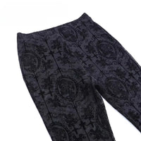 Laid flat against a white surface, this Longan Craft Stretch Floral Spandex Tulle Fabric features a richly patterned black velvet flocked gothic design with crosses, swirls, and cameo silhouettes—ideal for fashionable dressmaking projects.