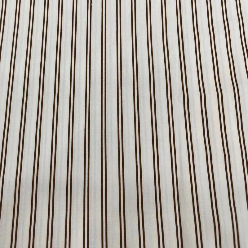 The Striped Cotton Lawn Fabric by Longan Craft features evenly spaced vertical brown stripes on white cotton, offering a simple, classic look—ideal for summer apparel and dressmaking projects. Available by the yard.
