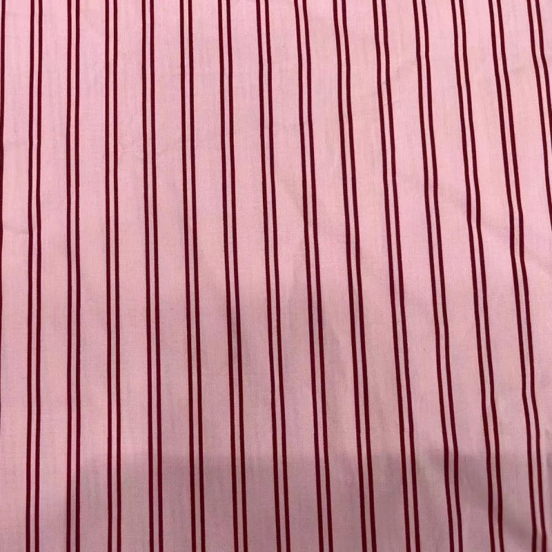 A close-up of Longan Craft's Striped Cotton Lawn Fabric By The Yard with vibrant vertical stripes, ideal for dressmaking projects or summer cotton shirting. This colorful printed lawn fabric adds stylish flair to your creations.