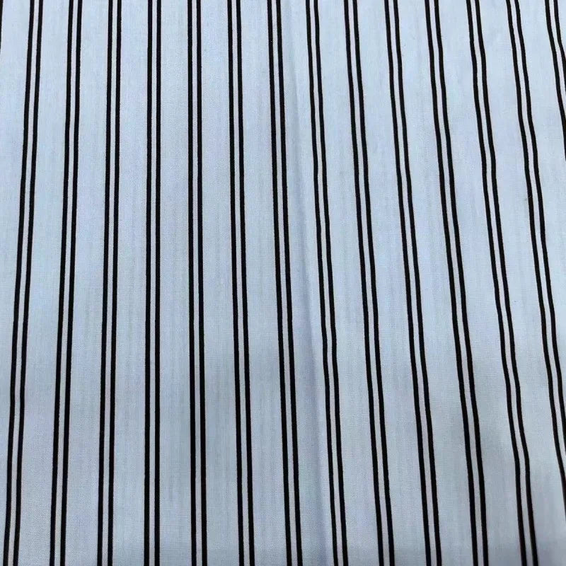 A close-up of Striped Cotton Lawn Fabric By The Yard by Longan Craft displays its colorful printed stripes, making this cotton lawn dressmaking fabric ideal for summer apparel or lightweight shirting.