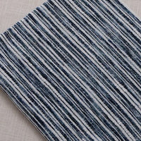 A Longan Craft Striped Jacquard Chenille Fabric By The Yard features durable, colorful poly woven stripes in blue, gray, and white—ideal as stylish upholstery material for modern interiors.
