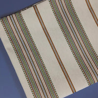 Longan Craft’s Striped Jacquard Chenille Fabric By The Yard showcases vertical brown, green, and purple stripes on a cream and blue background. This high-quality 100% poly chenille upholstery fabric adds decorative texture to cushions or furniture.