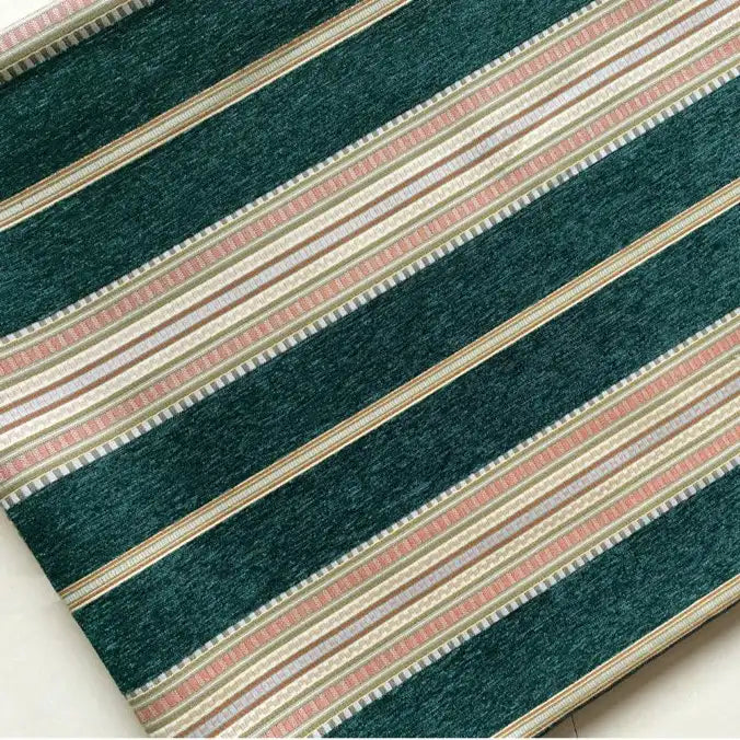 A close-up of Longan Craft’s Striped Jacquard Chenille Fabric By The Yard features diagonal dark green, white, beige, and pinkish-tan stripes in a repeated pattern—perfect high-quality 100% poly chenille for cushion upholstery projects.