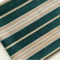 A close-up of Longan Craft’s Striped Jacquard Chenille Fabric By The Yard features diagonal dark green, white, beige, and pinkish-tan stripes in a repeated pattern—perfect high-quality 100% poly chenille for cushion upholstery projects.