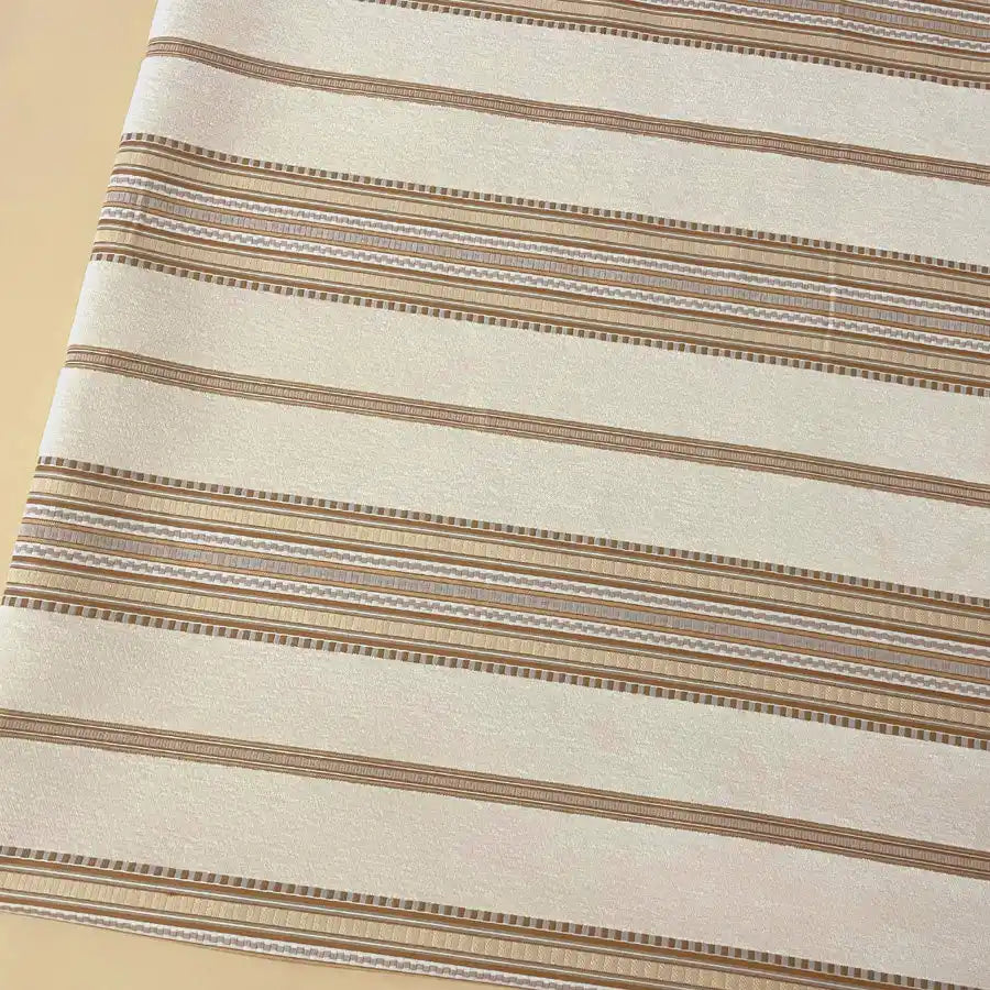 The Longan Craft Striped Jacquard Chenille Fabric by the yard is a high-quality, 100% poly upholstery material in beige with horizontal brown and light tan stripes—perfect for cushions or decorative accents.