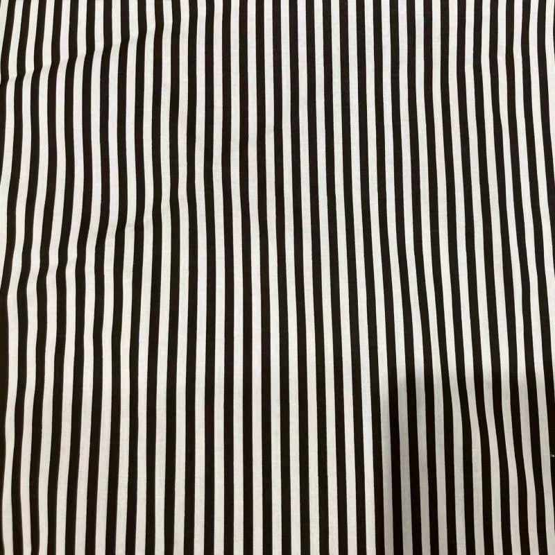The Longan Craft Striped Print Lawn Fabric features closely spaced black and white vertical stripes on pure cotton, with a soft texture and subtle wrinkles, perfect for shirts. Sold by the yard.
