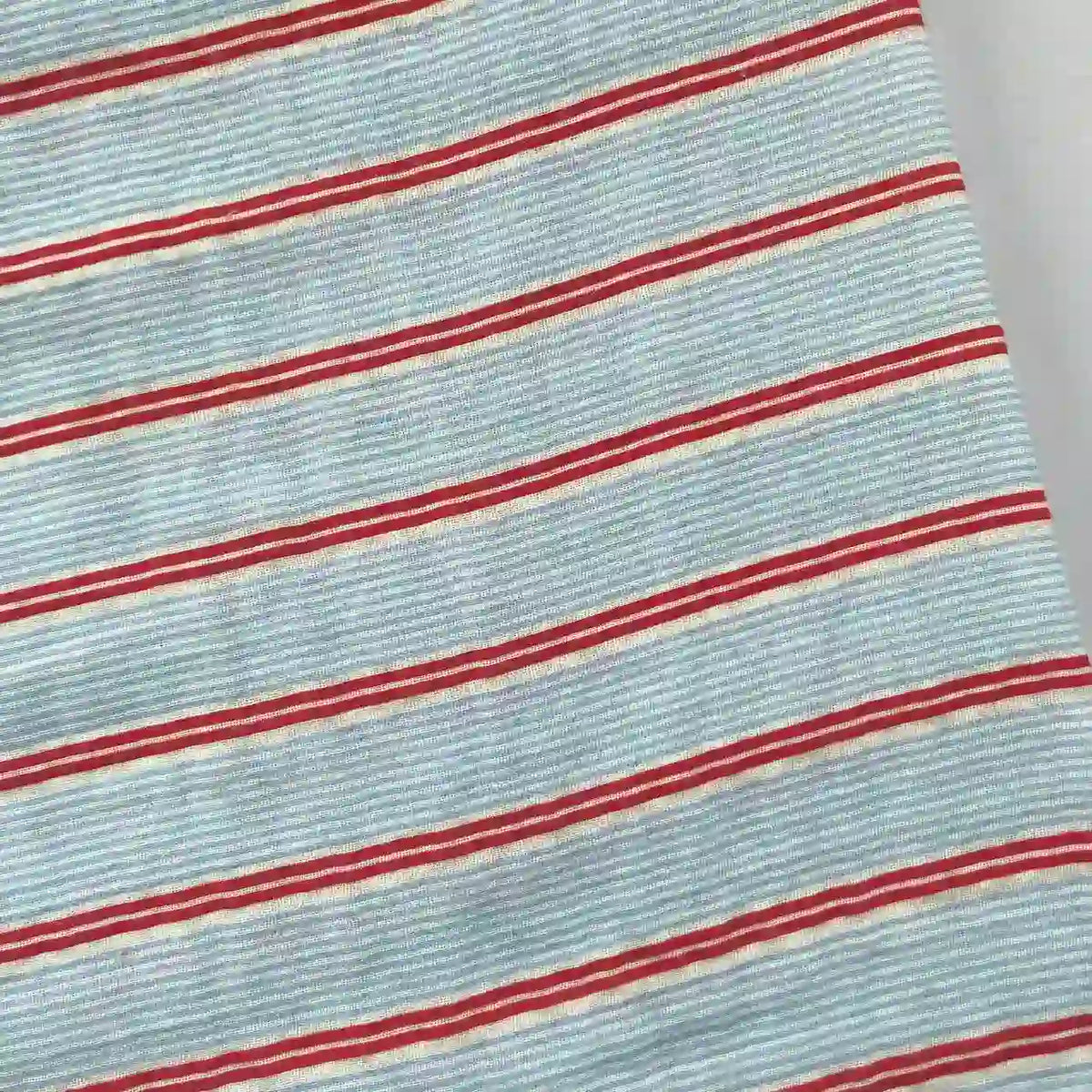 Close-up of Longan Craft's Striped Printed Gauze Fabric By The Yard—double 100% cotton gauze with thin white lines and red stripes. This breathable, cozy material offers a simple, classic look—perfect for casual projects.