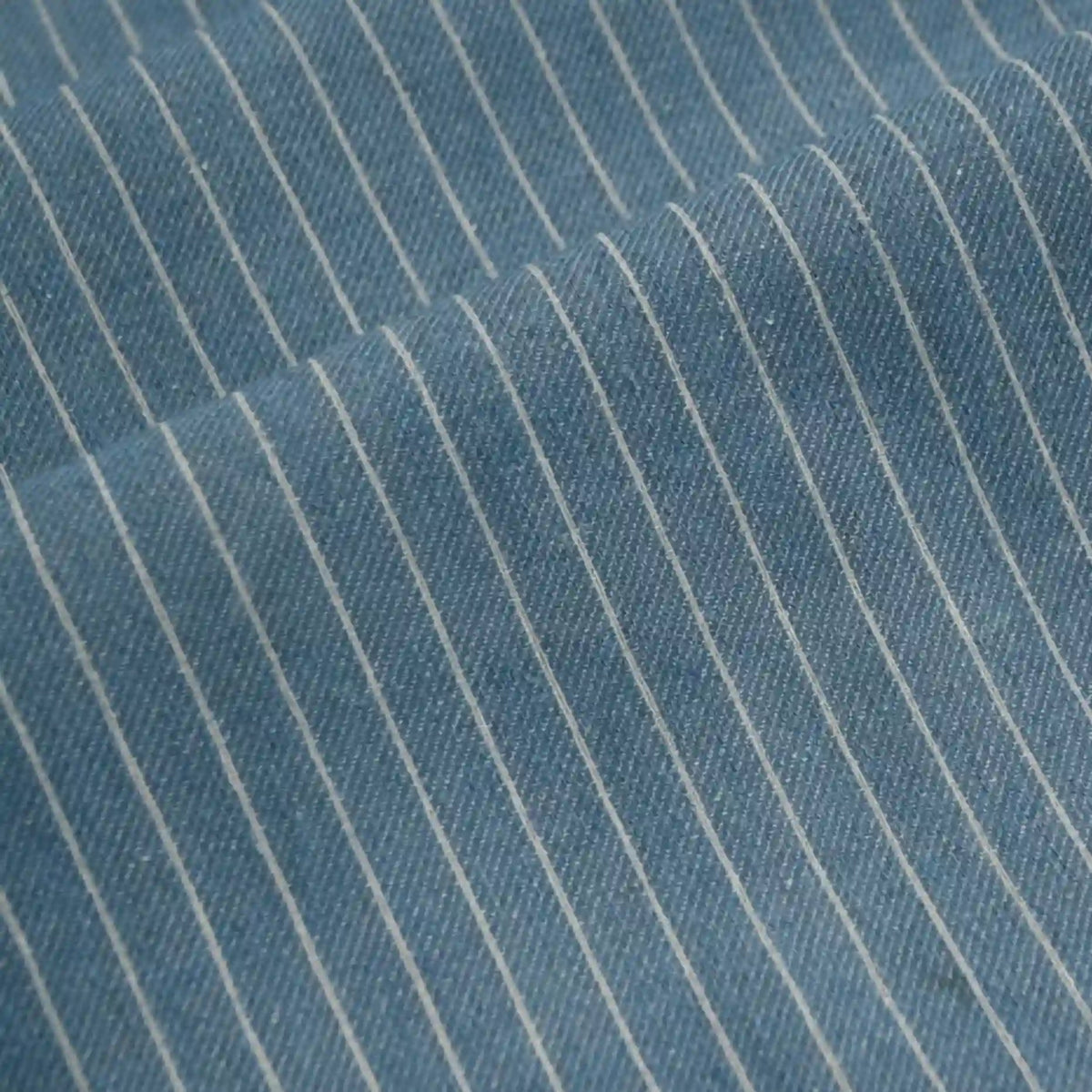 Close-up of Longan Craft’s Striped Printed Linen Fabric By The Yard, a cotton linen blend with colorful stripe pattern, highlighting the breathable fabric’s texture and a diagonal fold in the material.