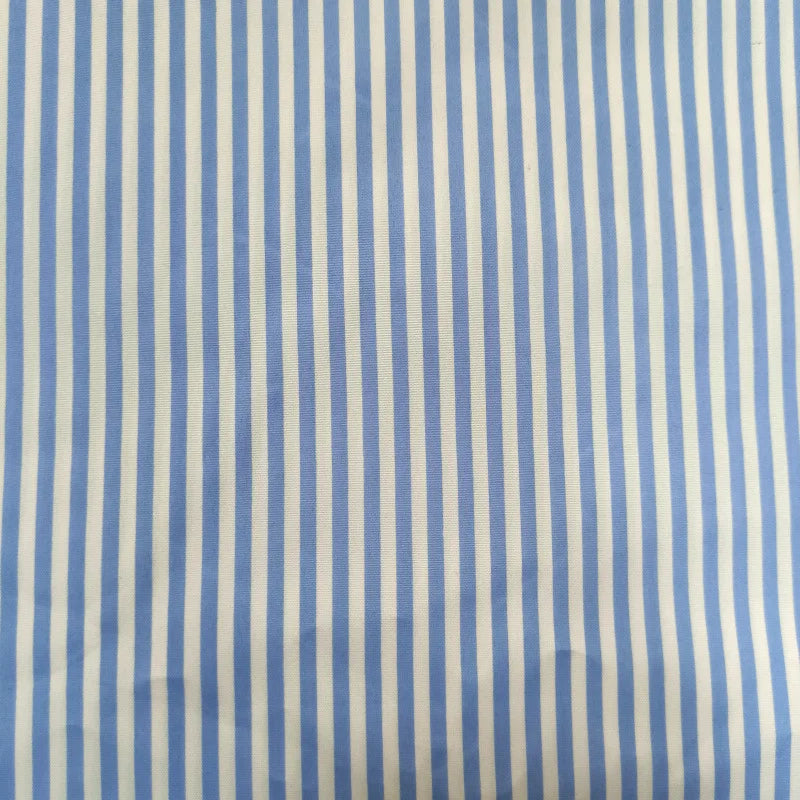 A close-up of Longan Craft's Striped Printed Peachskin Fabric By The Yard shows evenly spaced vertical blue and white stripes on soft, slightly wrinkled polyester peachskin material, perfect for DIY clothing projects.