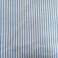 A close-up of Longan Craft's Striped Printed Peachskin Fabric By The Yard shows evenly spaced vertical blue and white stripes on soft, slightly wrinkled polyester peachskin material, perfect for DIY clothing projects.