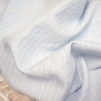 Longan Craft Striped Rayon Dobby Fabric By The Yard features soft blue and white vertical stripes with a subtle crumpled look and jacquard dobby texture, perfect for blouses and elegant projects.