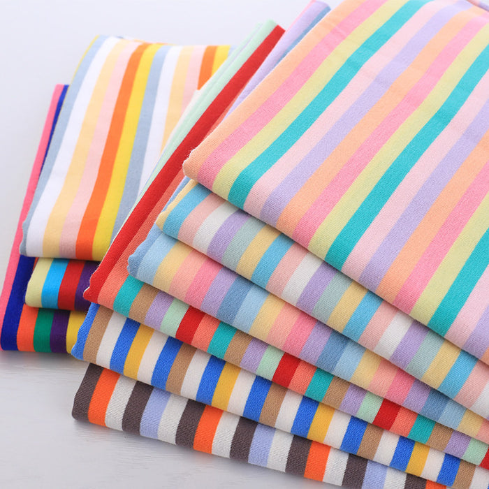 A stack of colorful Striped Jersey Fabric By The Yard from Longan Craft, made from soft and stretchable cotton spandex jersey, perfect for comfy DIY short sleeves.