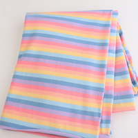 Longan Craft’s Striped Jersey Fabric By The Yard features pastel blue, yellow, pink, and purple stripes. This stretchable cotton spandex jersey is perfect for comfy DIY short sleeves and crafted for versatile use. Displayed on a white surface.