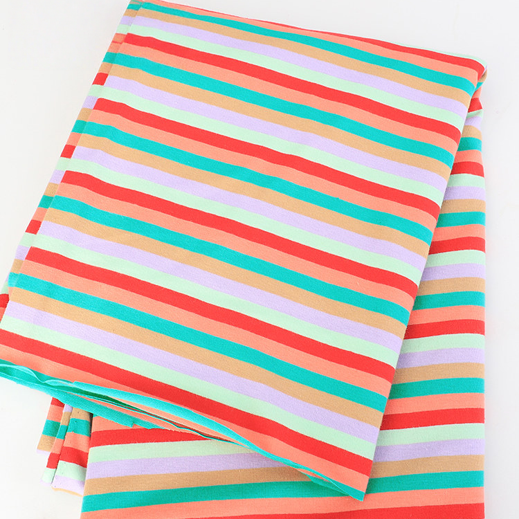 Longan Craft Striped Jersey Fabric By The Yard: stretchable cotton spandex jersey with bright horizontal stripes in red, green, orange, purple, and beige on a white background—ideal for DIY short sleeves.