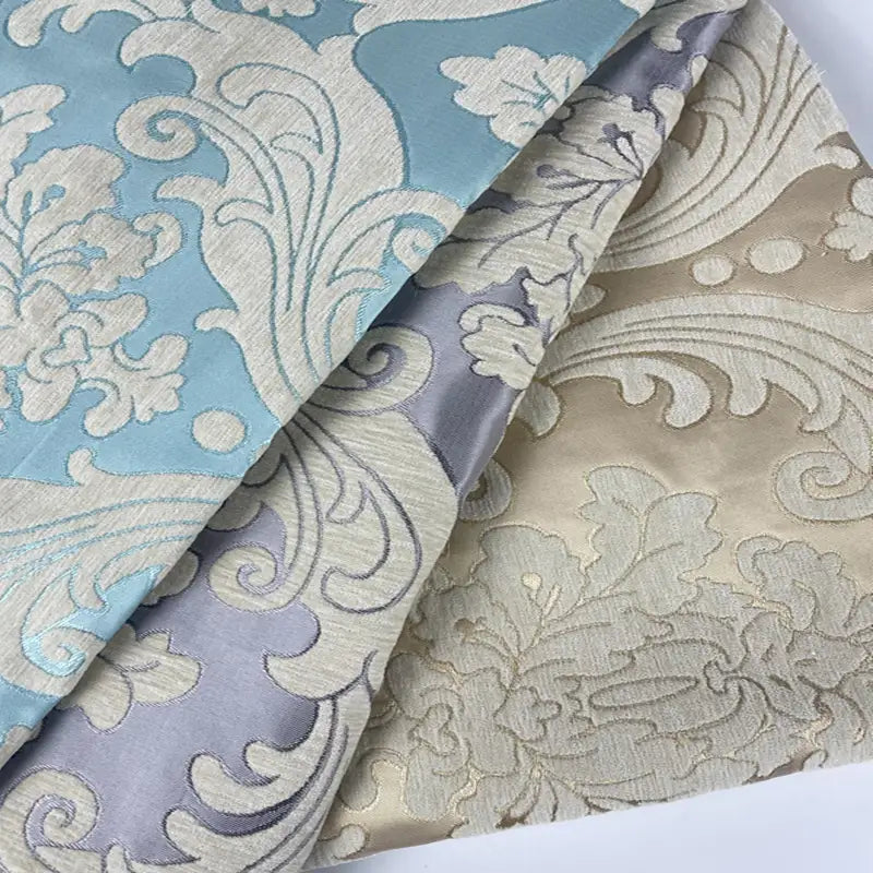 Three pieces of Longan Craft Thick Chenille Damask Fabric By The Yard feature vintage jacquard damask patterns in pastel blue, gray, and beige—ideal upholstery fabric for elegant home décor projects.