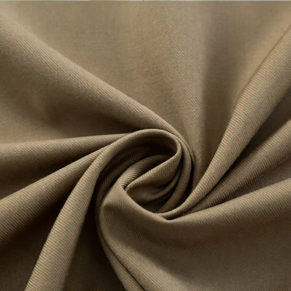 Close-up of Longan Craft’s Thick Cotton Gabardine Fabric By The Yard, a plain color twill ideal for uniforms, twisted to highlight its smooth texture and soft folds.